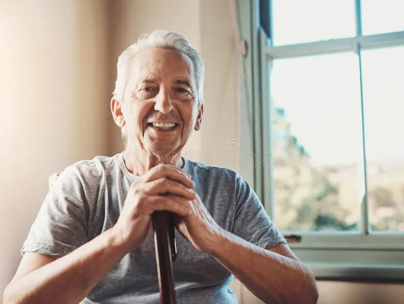 smile-walking-stick-portrait-senior-man-home-confidence-support-wellness-happy-parkinson-elderly-person-329740289.webp